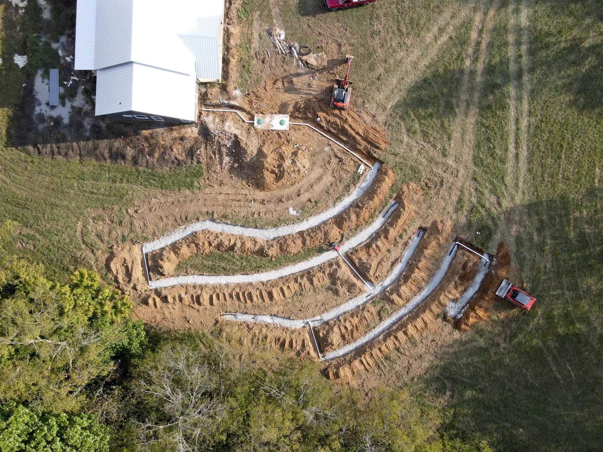 J.R. Outdoor Solutions septic and excavation equipment working on site